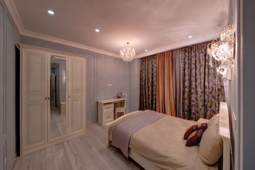 The light blue bedroom with a two-door case, a bed and a table