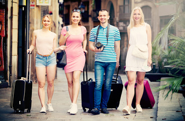 four tourists taking walk