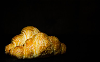 two croissants on dark wooden background. with copy space.