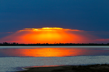 Multicolored sunset colors over the laken after a summer storm