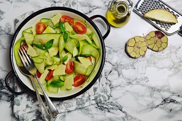 Fresh zucchini salad on the light background. Top view