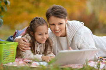 woman and  girl  using  laptop