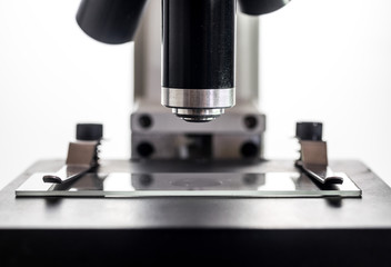 Microscope and microscope glass slide closeup macro, backlit, white background