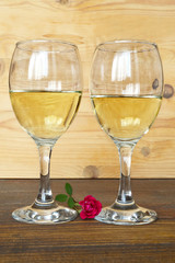 Two glasses of wine on wooden background