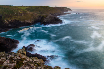 Cliffs in Cornwall/GB. Long exposure shot of waves crashing against the rocks.
