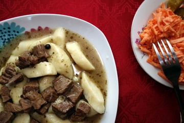 Kopytka with meat sauce - traditional polish dumplings 