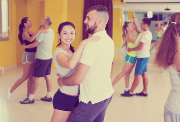 Smiling people dancing waltz