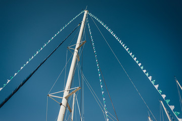 Yacht masts in blue sky background