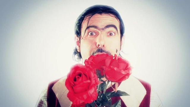 An ugly nerd offering us red roses and moving his tongue in a sexual way. Sickening fake character.
