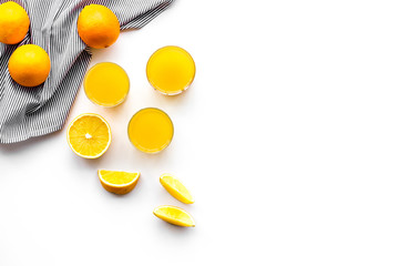 Healthy vitamin drink. Fresh orange juice near orange slices on white background top view copyspace