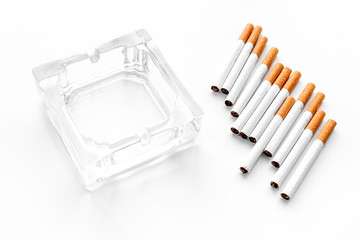 Smoking. Half-smoked cigarettes near ashtray on white background mockup