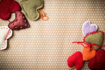 Fototapeta na wymiar Valentine's Day. Colorful knitted hearts on a vintage background in polka dots. Red heart. Valentines day. Heart pendant. Valentine cards. Eighth of March. International Women's Day.