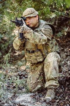Army sniper during the military operation in the mountain. war, army, technology and people concept.