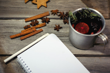 Traditional fruity mulled wine from the old mug, on an old wooden table