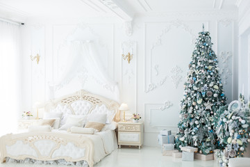 Christmas decorations in a beautiful bright bedroom.