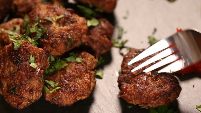Eating meatballs with tomato sauce