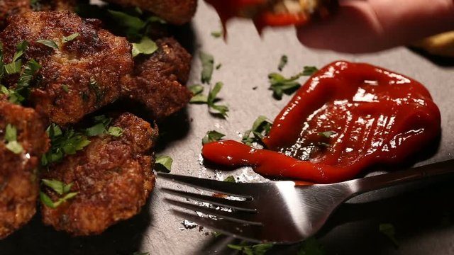 Eating meatballs with tomato sauce