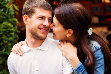 a close-up of two lovers laughing at each other