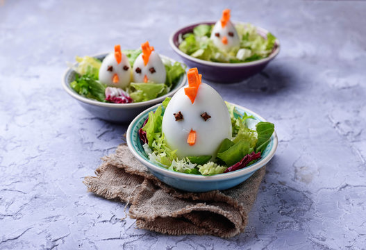 Salad with eggs in shape of chickens. Festive food.