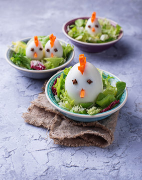 Salad with eggs in shape of chickens. Festive food.