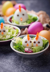 Salad with eggs in shape of chickens. Festive food.