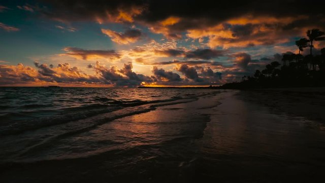 Sunrise sea view and dramatic cloudscape over tropical island beach.