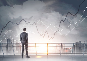 Businessman looking at a gray city, graphs