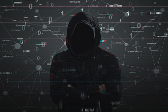 Hacker in a black hoodie, binary code