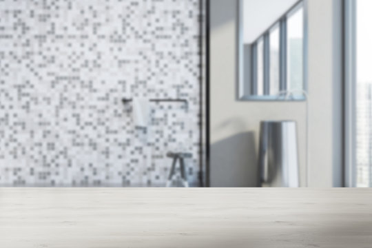 Gray tiled bathroom, sink and shower blur