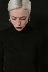 Beautiful emotional girl with white hair on a black background