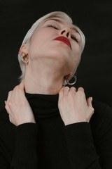 Beautiful emotional girl with white hair on a black background
