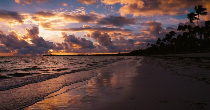Sunrise sea view and dramatic cloudscape over tropical island beach.