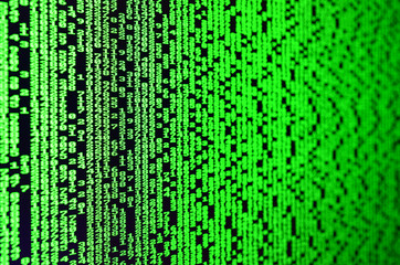 Macro of password selection on the monitor of the office computer. The concept of hacking the protection of a personal data keeper. The stream of supposed digital passwords of four and five digits