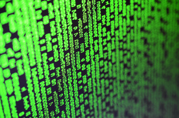 Macro of password selection on the monitor of the office computer. The concept of hacking the protection of a personal data keeper. The stream of supposed digital passwords of four and five digits