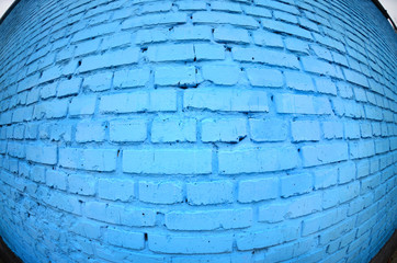 Large brick wall, painted in blue. Fisheye photo with pronounced distortion