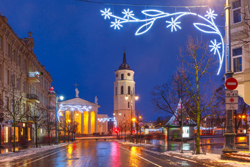 Fototapeta na wymiar Decorated and illuminated Christmas Gediminas prospect and Cathedral Belfry during evening blue hour, Vilnius, Lithuania, Baltic states.