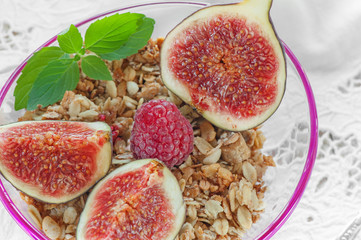 A healthy Breakfast of figs, cereals and fruit with nuts and mint. Close-up. A horizontal frame.