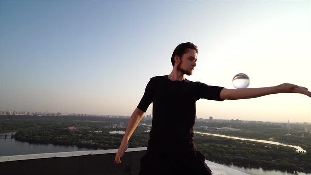 Young contact juggler demonstrates his incredible abilities with acrylic balls 4K