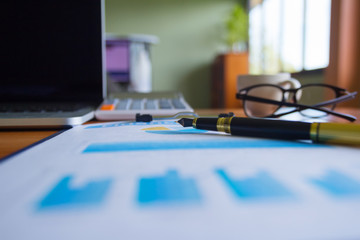 Pen,keyboard,calculator,report graph chart on office table,for Business.