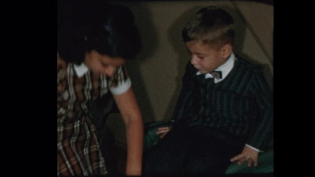 1957 Little boy gets and tries out vintage antique rollerskates