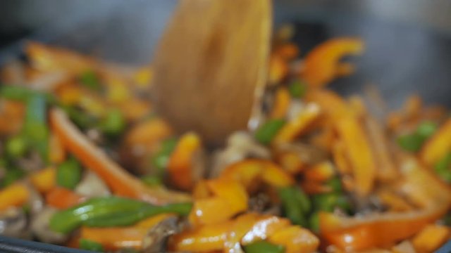 Fresh sliced fresh peppers and mushrooms stir fry close up