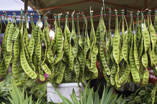 Parkia speciosa (petai) hanged to a rope for sale at local fresh market