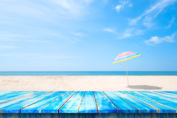 Blue wooden table top on blurred beach background