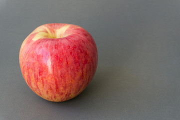Fresh red apple on grey background, fruit health care concept