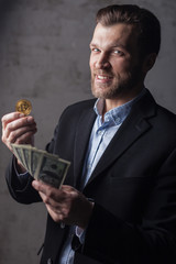 Smiling man holding money and bitcoin. Focus on face
