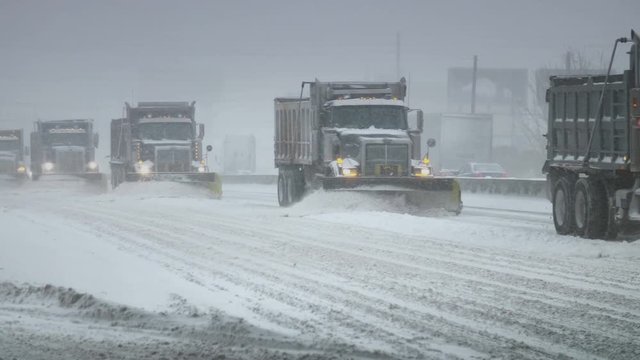 Snow Plows clearing a highway during a blizzard