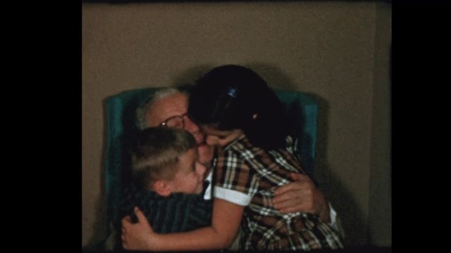 1956 Grandfather gets hugs and kisses from grandchildren