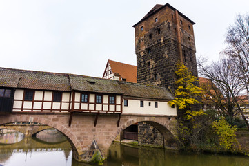 medieval bridge over river Pegnitz with reflection in the water and Henkerturm tower in Old Bavarian city Nuremberg Germany, Nurnberg middle Franconia.