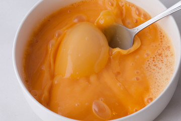 preparing omelet .Cooking of eggs in White Ceramic Bowl.