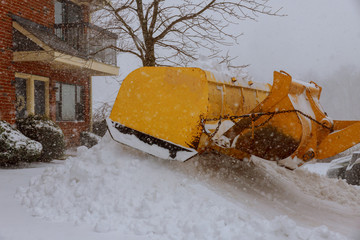 Snow remover truck cleaning city streets in snow storm